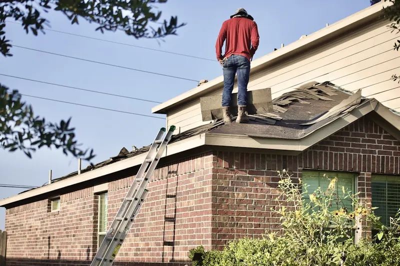 Professional roofer working on a residential roof in Lake View